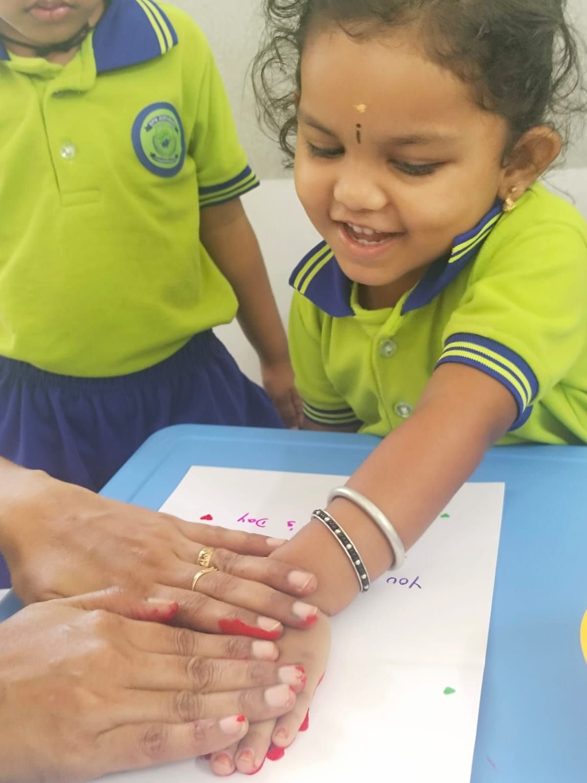 A student doing a handprint painting activity